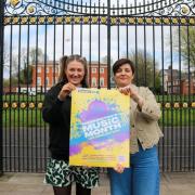 Amber Dawbler and Andrea Morley holding Warrington Music Month's poster