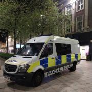 A man has been arrested for urinating against a police van in Warrington town centre