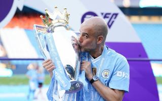Pep Guardiola kisses the Premier League trophy (Martin Rickett/PA)