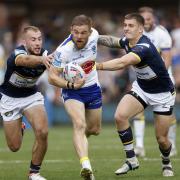Matt Dufty looks to escape the Leeds defence