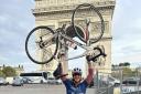 Cricketer Rob Jones celebrates completing his Paris to London cycle ride