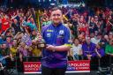 Luke Littler shows off the Belgian Darts Open trophy after he beat Premier League rival Rob Cross in the final, hitting a nine-darter in the process
