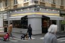 Parisians walk by the Utopie bakery in Paris (Thibault Camus/AP)
