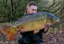 Josh Bamber with the 25lb 7oz mirror carp he caught at Appleton Reservoir on his final night outing of 2022