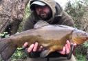 Jay Makin with one of the tench he caught at Grey Mist