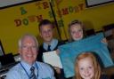 Neil Walsh receives present from pupils pictured from front to back Charlotte Davies, Jessica Cupples and Jakub Rompa