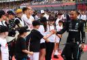 Luca Narraway fist-pumps with race star Lewis Hamilton at Silverstone