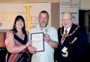 Winner Ste Dodd with Mayor Clr Peter Carey and sponsor Angela Perry, director of property services at Golden Gates Housing
