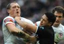 Wolves' Ben Westwood is fended by Roger Tuivasa-Sheck's clenched fist. Pictures by Mike Boden