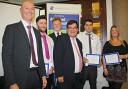 Andrew Carr, director at Hinton House (left) and Steven Broomhead, chief executive of Warrington Borough Council (front middle) congratulating the young apprentices on their new jobs with Sellafield
