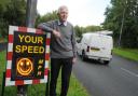 Cllr Brian Axcell next to the speed meter in Appleton