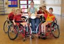 Liverpool Lions Wheelchair Rugby Club player-manager Martin Beddis with Stockton Heath Primary School pupils
