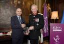 Home Instead Senior Care's UK managing director Martin Jones, left, receives the award from Lord Lieutenant of Cheshire David Briggs at the official ceremony