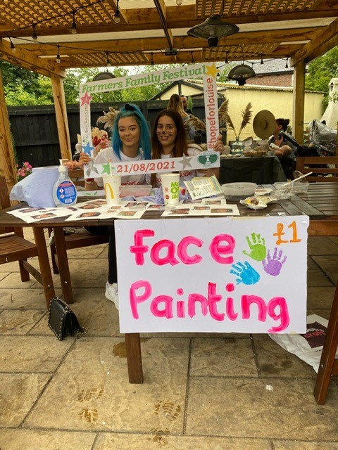 A face painting stall in the field for the kids