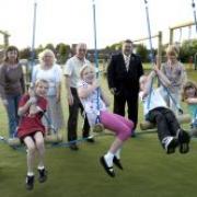 Children and governors try out the new swings at Longbarn Primary School  mbp220507