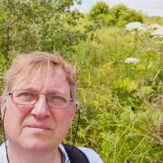 Cllr Nigel Balding is urging residents to report signs of dangerous plant life.