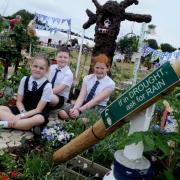 Bruche Primary School pupils Poppy Davidson-Wright, Mason Scholes and Elizabeth Williams in their allotment at the RHS Tatton Flower Show