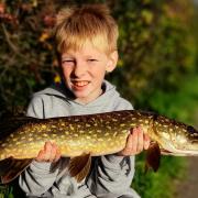 Cameron Daley, 9, with one of his pike catches on the Bridgewater Canal