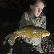 Ten-year-old Koree Finch with the personal-best tench he caught at Grey Mist on Saturday