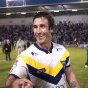 Andrew Johns shakes hands with Warrington Wolves owner Simon Moran after the win against Leeds Rhinos