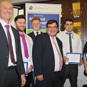 Andrew Carr, director at Hinton House (left) and Steven Broomhead, chief executive of Warrington Borough Council (front middle) congratulating the young apprentices on their new jobs with Sellafield