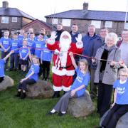 Father Christmas, Cllr Pat Wright and Dallam Primary children at the Molyneux Avenue Triangle opening DGG121214