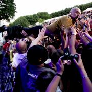 Tim Booth during his stage dive. Picture: Matt Sayle
