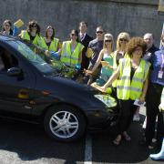 Relationships Centre staff and volunteers, right, clean up during the charity car wash