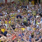 Warrington Wolves and Catalans Dragons fans cheering on their teams