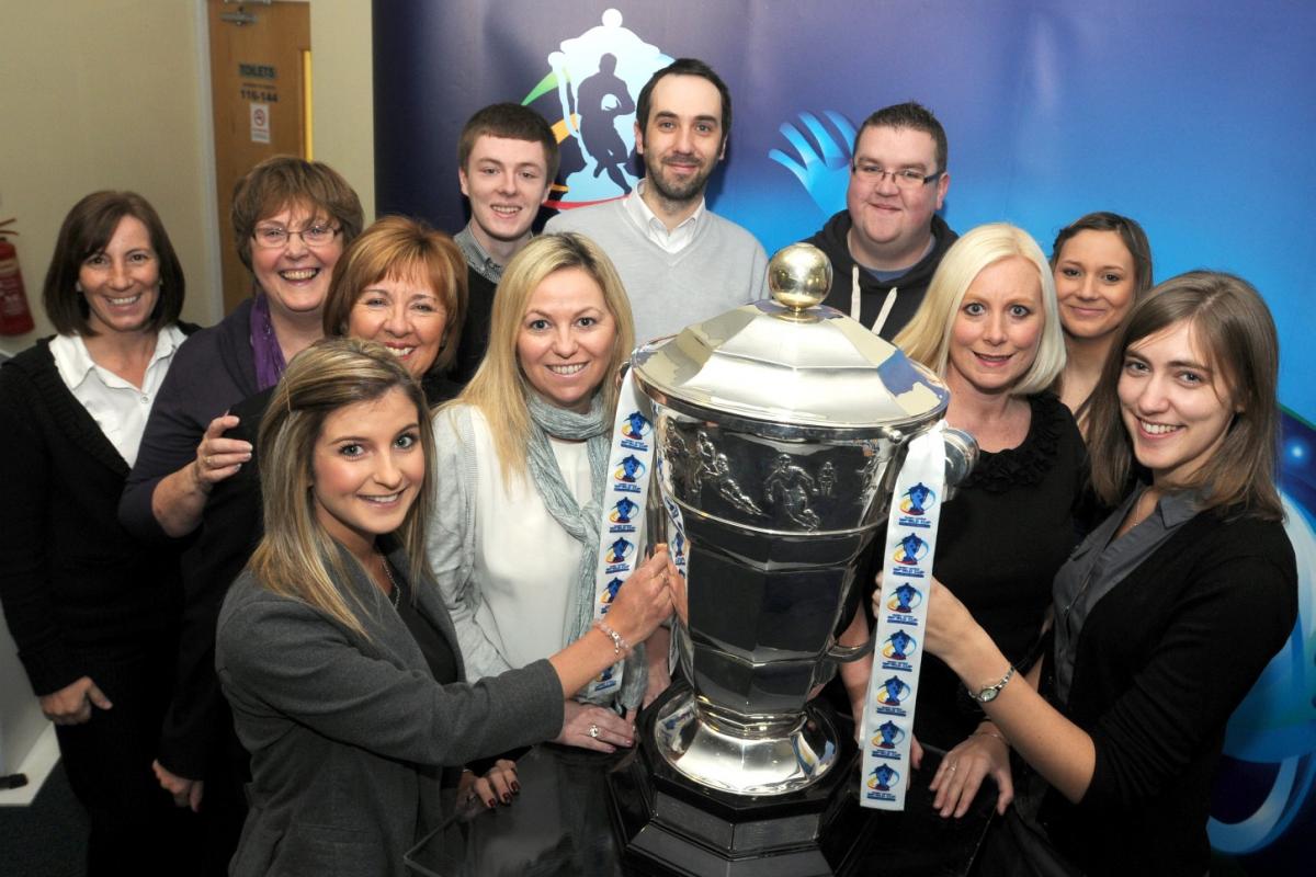 Staff at The Halliwell Jones Stadium with the cup