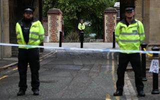 Police at the Abbey gateway of Forbury Gardens in Reading town centre following the multiple stabbing attack (Jonathan Brady/PA)