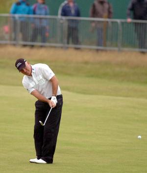 Phil Archer chips to within inches of the hole on the 18th