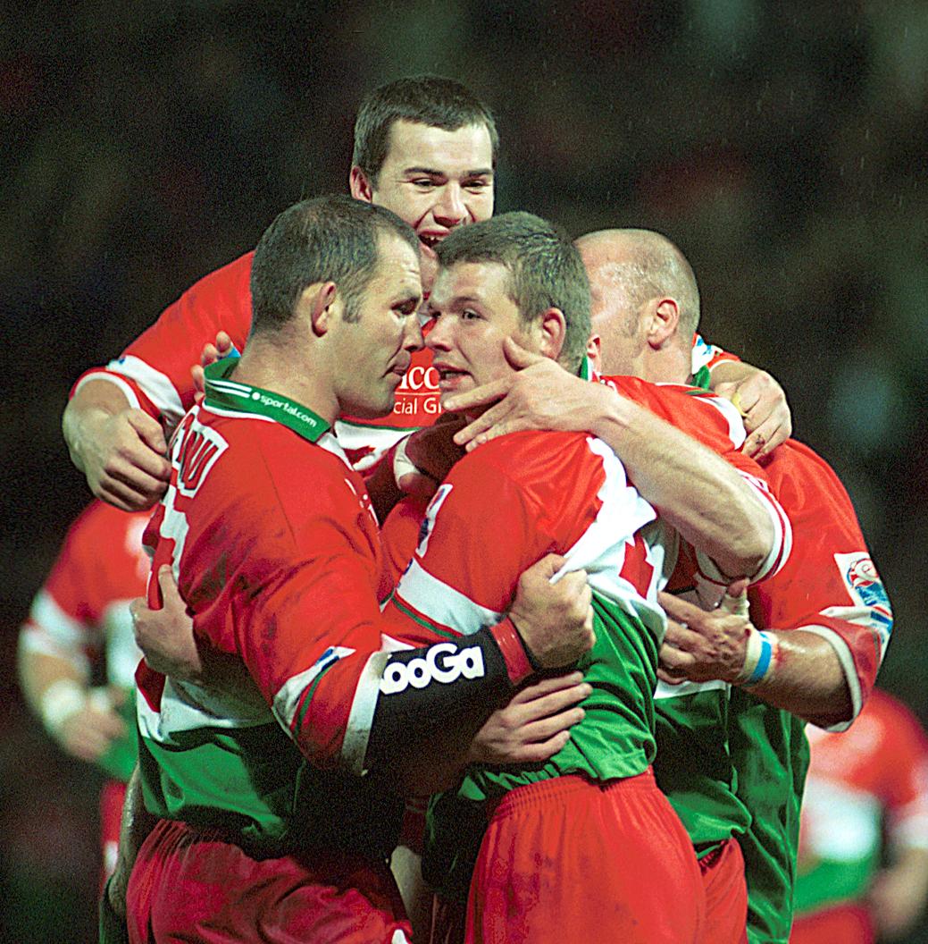 Lee Briers and Dean Busby are joined by Iestyn Harris in celebrating a score against Australia in the 2000 World Cup