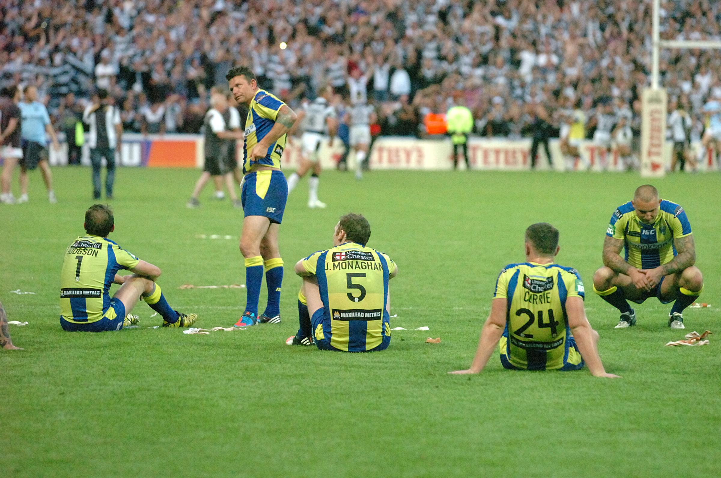 A dejected Wire camp comes to terms with their 2013 loss to Hull FC. Picture by Mike Boden