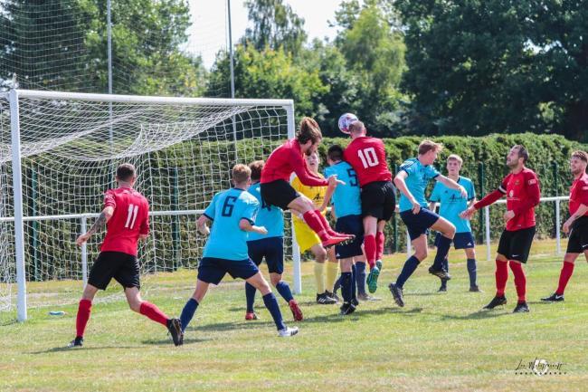 Stuart Wellstead, wearing the red number 10, heads home during Rylands first ever semi-professional match against Ellesmere Rangers in August 2018. Picture by Lee Wolstencroft