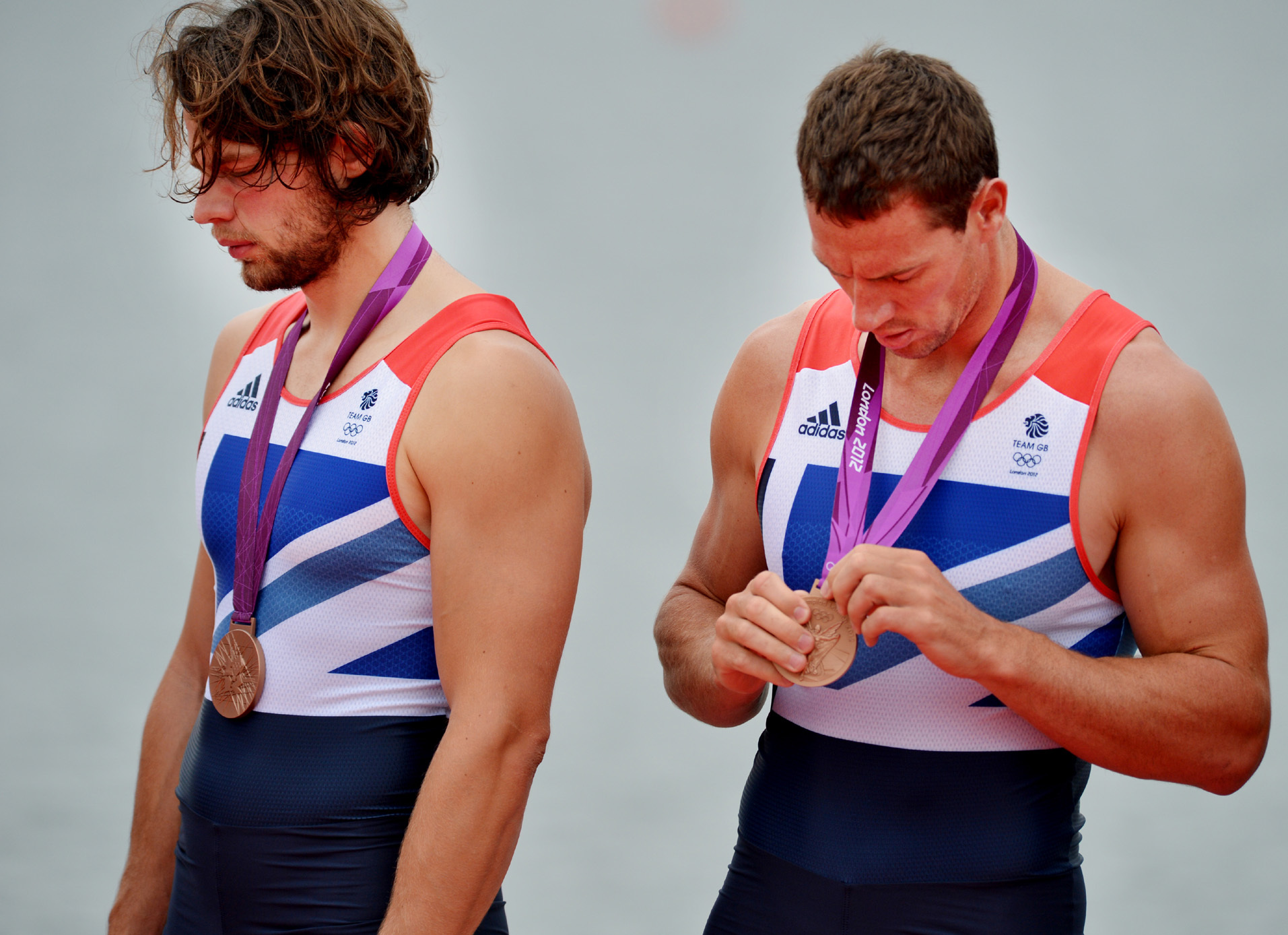 n 2012 > Men’s eight rower Richard Egington looks at his bronze medal for Team GB on the London Olympics podium