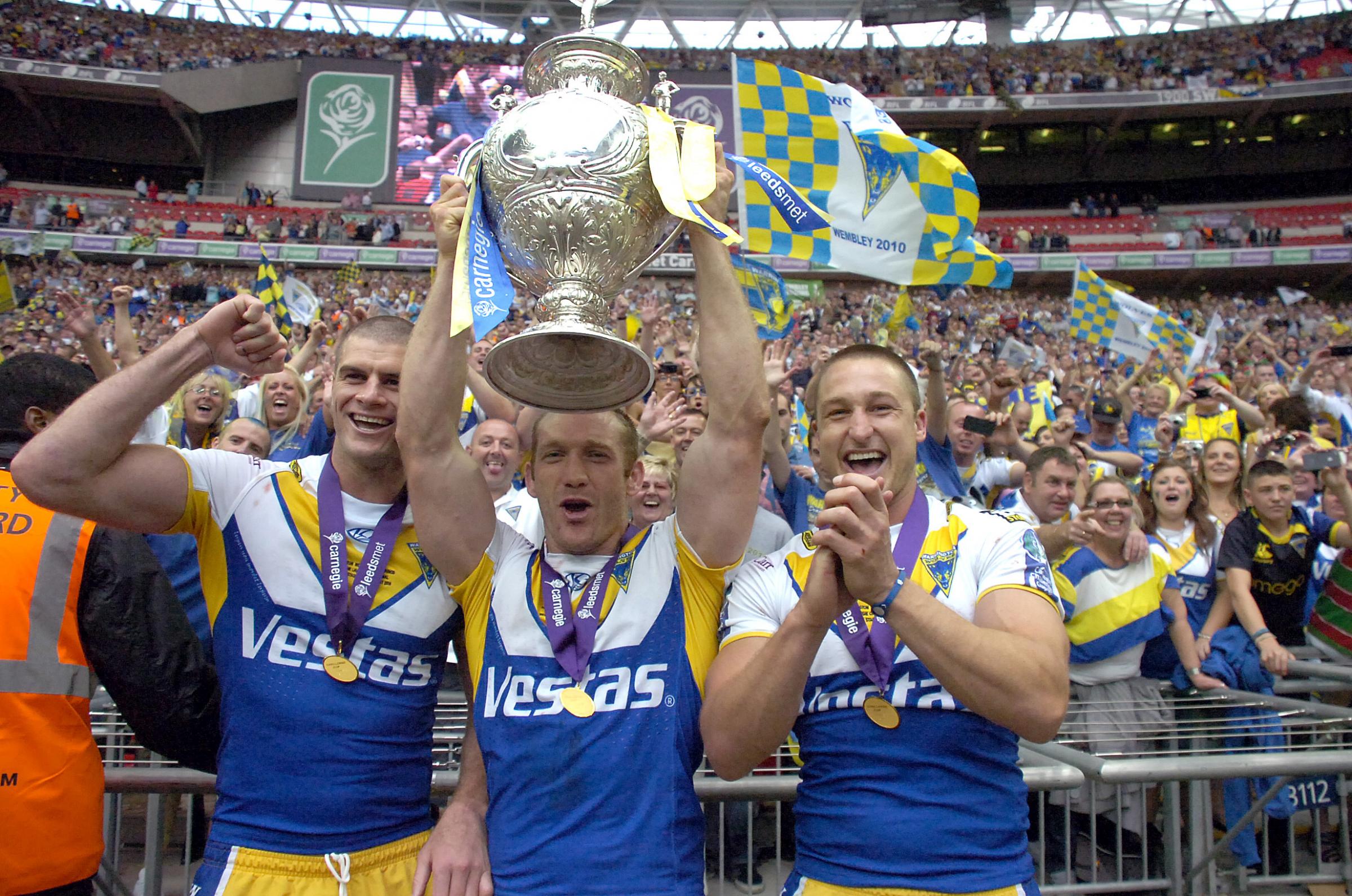 n 2010 > Matt King, Michael Monaghan and Chris Hicks celebrate Wire’s Challenge Cup Final win against Leeds