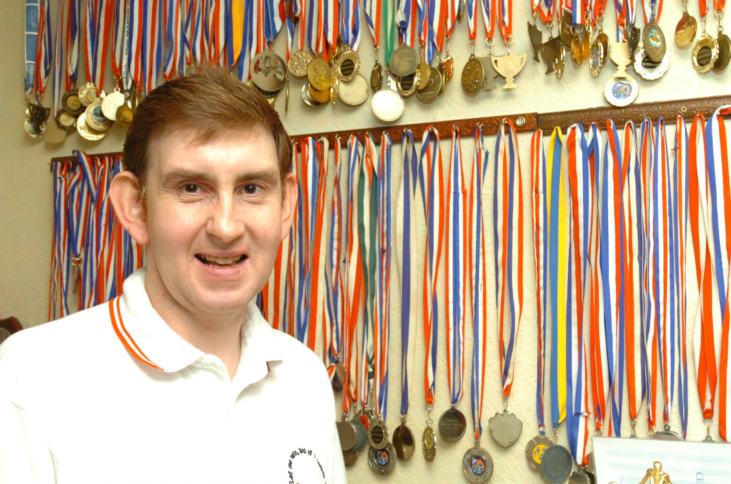 2006: Aden Walker with his incredible medal haul from disability swimming events