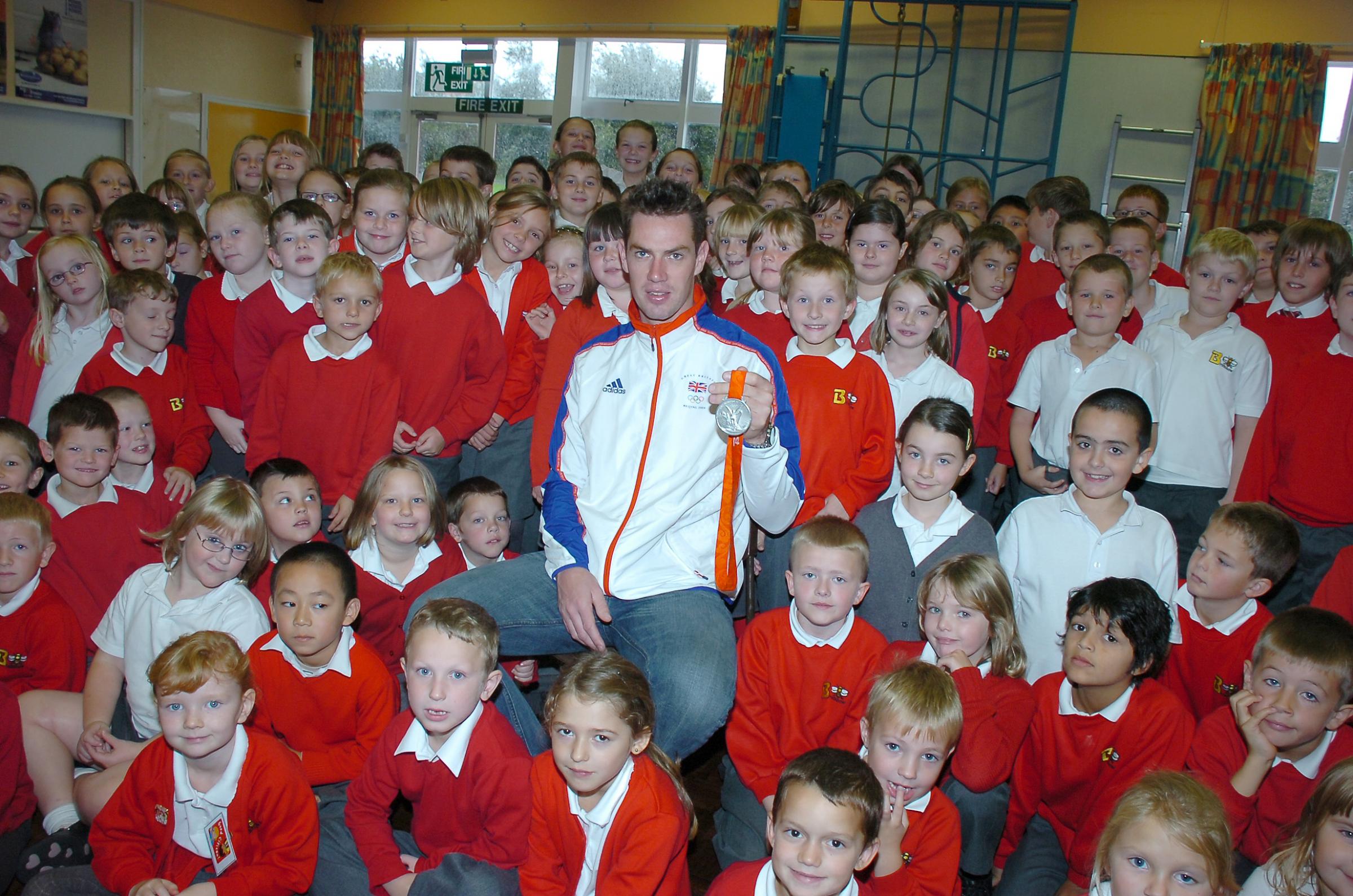 2008: Richard Egington shows schoolchildren the rowing silver medal he won at the Beijing Olympics