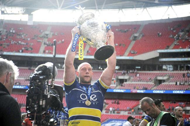 Chris Hill lifts the Challenge Cup. Picture by Mike Boden