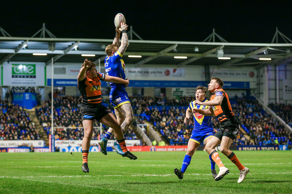 A busy East Stand watches on as Josh Charnley competes for a high kick. Picture by SWPix.com