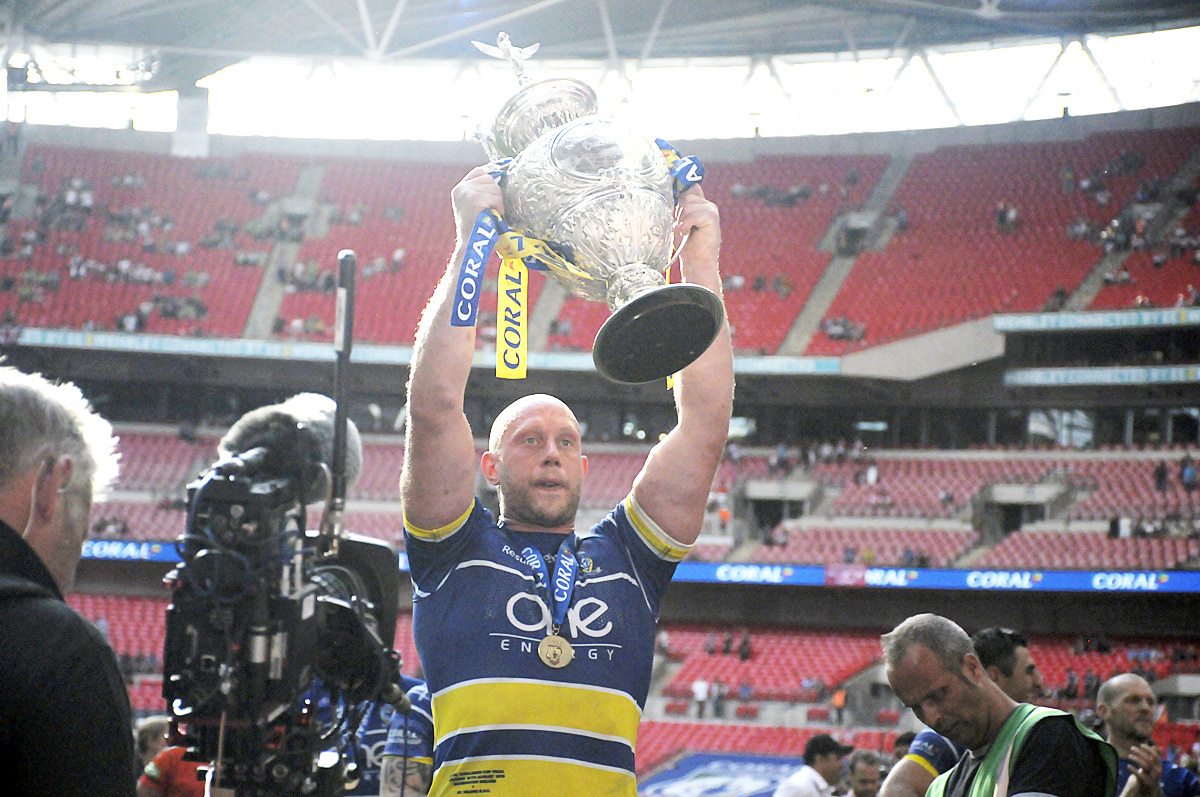 Hill lifts the Challenge Cup having co-captained The Wire to victory over St Helens at Wembley in 2019. Picture by Mike Boden