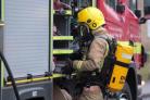 Firefighters wearing breathing apparatus tackled a blazing caravan torched in an arson attaack