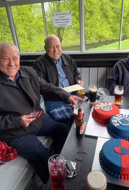 Twins Freddie and Ernie Bishop celebrate their 80th birthday with blue and red cakes to mark their different soccer teams