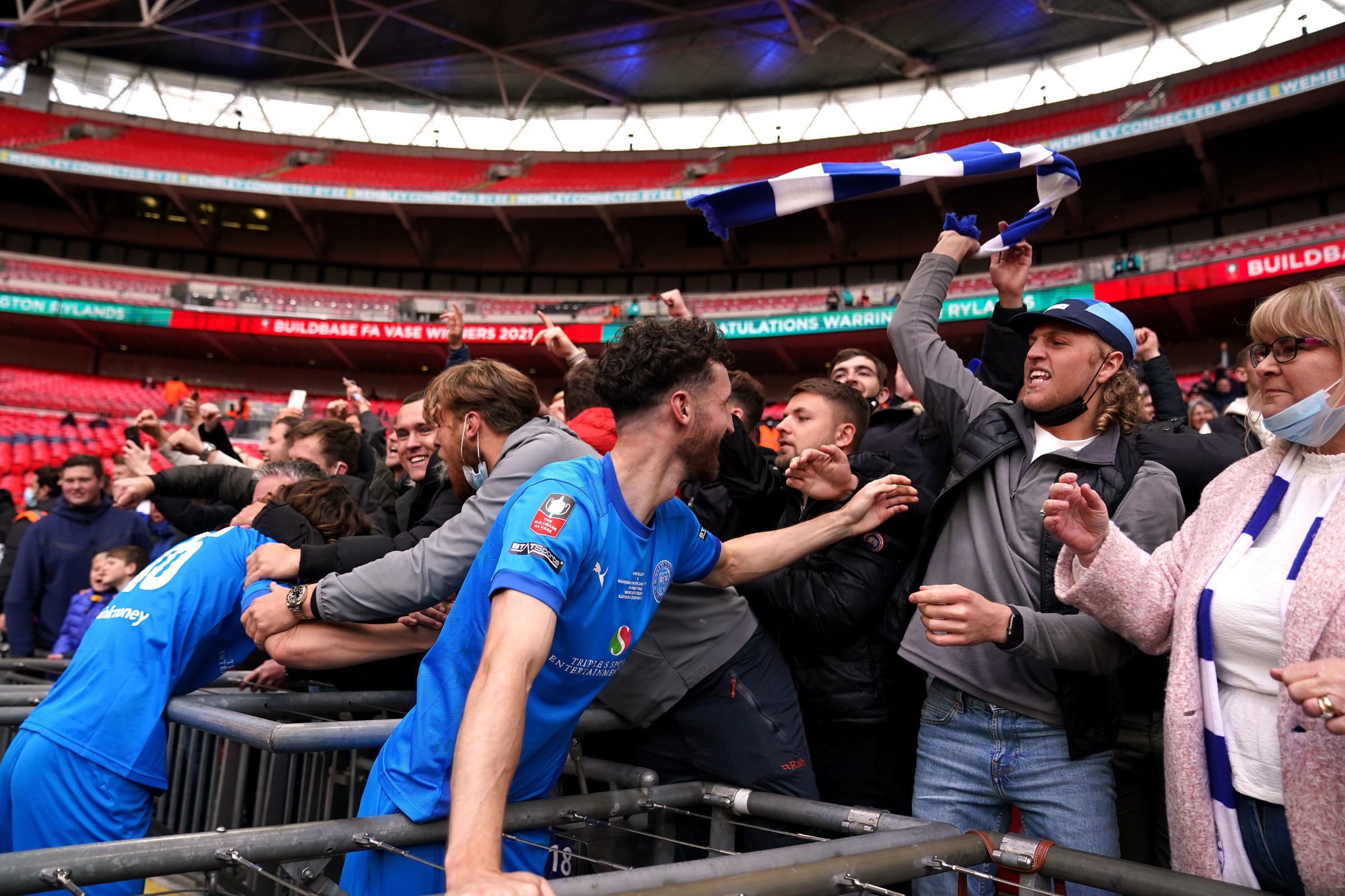 Warrington Rylands fans and players celebrate winning the Buildbase FA Vase 2020/21 Final at Wembley Stadium, London. Picture date: Saturday May 22, 2021. PA Photo. See PA story SOCCER Vase. Photo credit should read: Zac Goodwin/PA Wire. RESTRICTIONS: