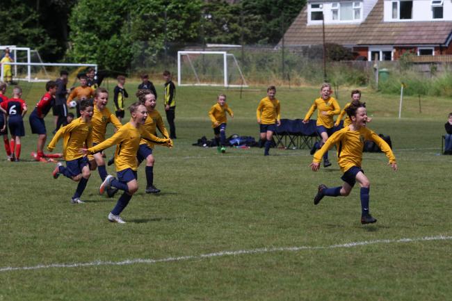 Bleak Hill Rovers race to congratulate the keeper after a penalty save that secured cup final success