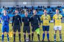 Tom Ellis as Warrington Town's mascot with skipper Mark Roberts, Whitby Town captain Daniel Rowe and the match officials ahead of kick off. Picture by Brian Murfield