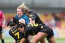 Abigail Latchford's progress for Warrington Wolves Women is stopped by three York Valkyrie defenders at the LNER Stadium