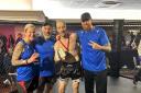 Ash Harrison, third from left, and Phillip Mannian, far right, with Warrior Muay Thai coaches Gemma Collins and Darren Collins