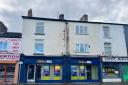Building home to betting shop and 2 flats is for sale in the town centre